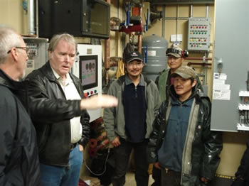 William Thomson explaining wind - diesel installation to Secretary of the Interior, Ken Salazar, in Chevak, Alaska